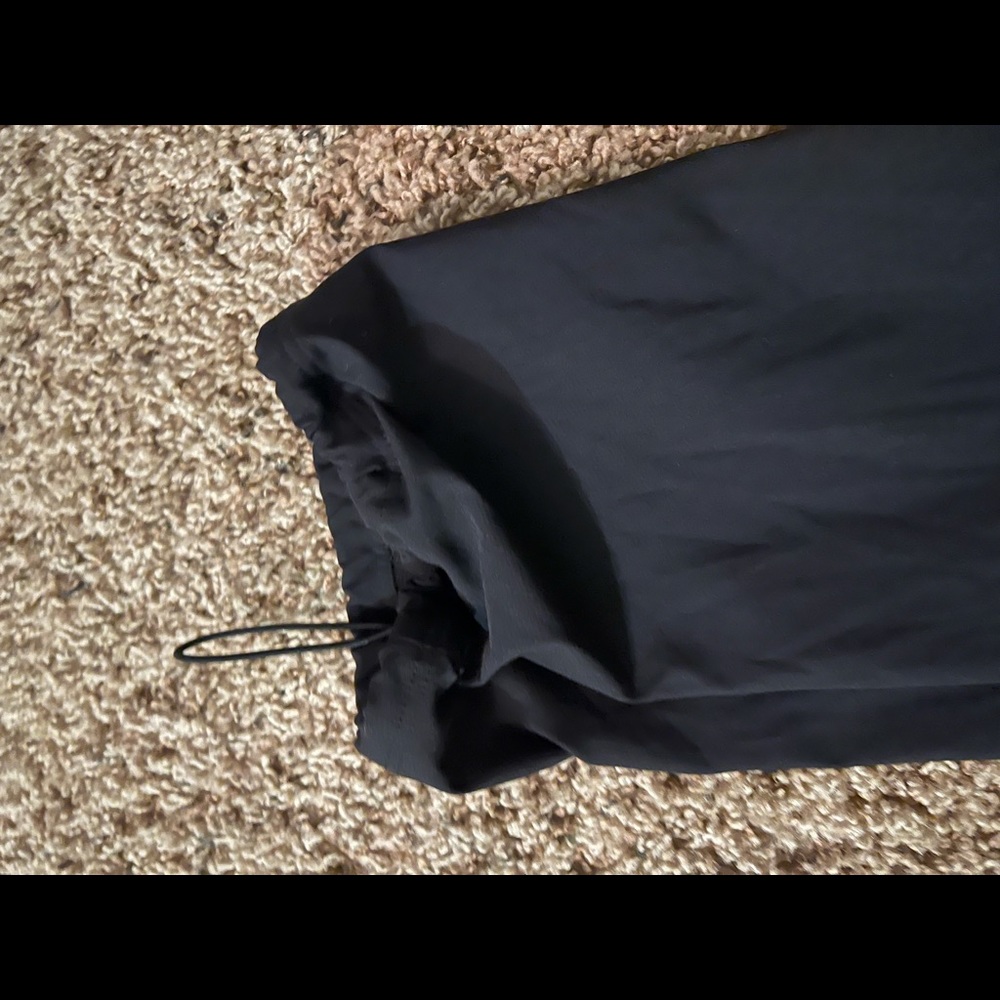 Athleta size 4 black pants. Stretchy. Pull-string cuff, pockets & side zippers. - Picture 7 of 7